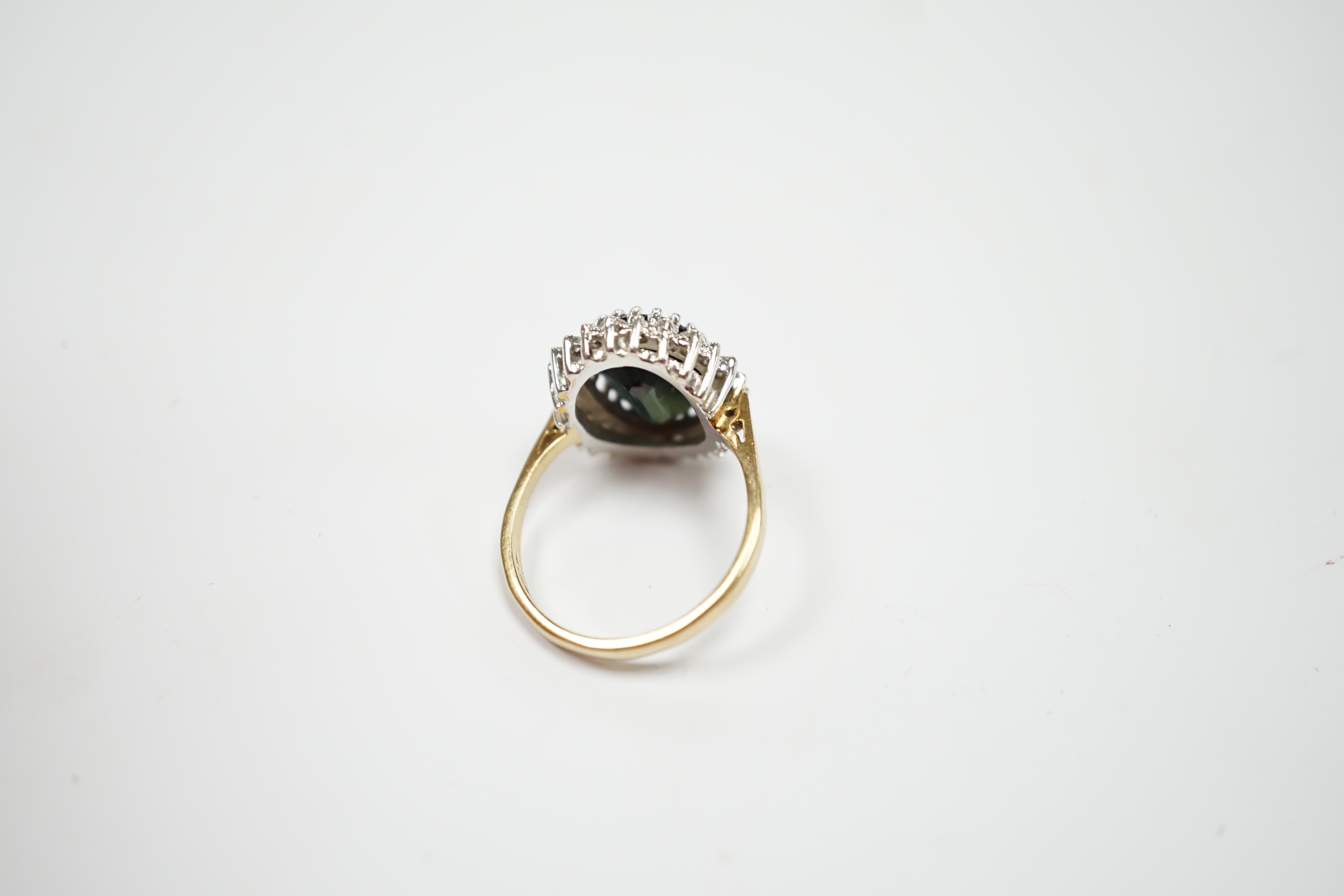 A modern 9ct gold, sapphire and diamond set oval cluster ring, size N/O, gross weight 4.8 grams.